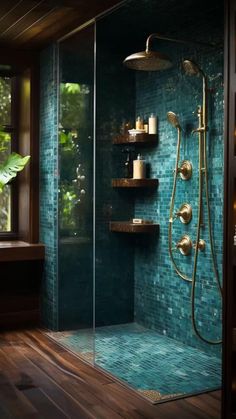 a walk in shower sitting next to a window with green tiles on the walls and floor