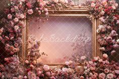 an ornate gold frame with pink flowers surrounding it