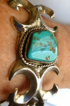 -Turquoise -Sterling Silver Braclet - Sand Cast Silver -Navajo Pawn Jewelry -Native American --50 grams -- Cuff  Bracelet -I bought this Pawn bracelet at a Navajo Pawn shop about 15 miles from Gallup, New Mexico. It is a Navajo sand casting in sterling silver. The bracelet weighs 50 grams and has a beautiful bright blue turquoise cabochon, with matrix .  Navajo  prefer turquoise with matrix. The turquoise is bezel set with twisted silver wire around the bezel. The outside of the bracelet measures 6 1/2 inches, the inside is  5 1/2 inches AND YOU CAN ADJUST IT TO YOUR WRIST.                                                        SALE--MARKED DOWN FROM $390 TO $339   AND FREE SHIPPING Bohemian Adjustable Untreated Bracelets, Bohemian Turquoise Sterling Silver Bracelet, Southwestern Untreated Bracelet Jewelry, Southwestern Style Natural Bracelet, Gallup New Mexico, Tufa Casting, Turquoise Bracelets, Vintage Native American Jewelry, Silver Turquoise Jewelry