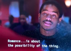 a man is looking at the camera with an ad in front of him that says romance is about the positivity of the thing