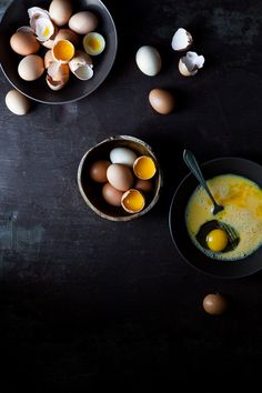 two bowls filled with eggs on top of a table