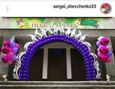 an arch decorated with purple and pink balloons in front of a sign that reads, i hope for a date