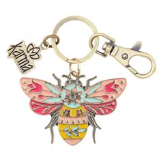 a metal keychain with a pink and yellow bee on it's side