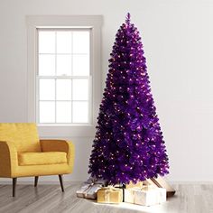 a purple christmas tree sitting next to a yellow chair