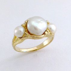 This Ring is from the ' Sea ' Collection. They are all inspired by the ever changing aspects of the Indian ocean.The pearls  are Burmese  fresh water pearls. The setting in 9 k gold, has been hand carved in wax, to fit the exact shape of the pearls.The Ring is sized at '14' or, 'M 1/2 ' It can be resized, or I can create a bespoke jewel in a similar style, to your exact size. As the pearls are all natural, there is always variety. Free Shipping.Code; MYP R13.2 Unique Yellow Gold Pearl Ring For Wedding, Unique 14k Gold Pearl Ring For Wedding, Unique 14k Gold Pearl Wedding Ring, Tahitian Pearls Jewelry, Natural Pearl Ring, Glamorous Jewelry, Pearl Rings, Pearls Jewelry, Nature Inspired Rings