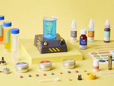 an assortment of medical supplies are displayed on a yellow surface with other items around it