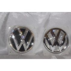 two vw emblems with diamonds on them