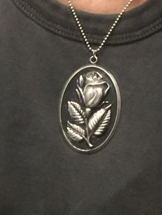 "this is a vintage sterling silver pendant with a rose made by International Silver Company (stamped on back).  The oval shape measures approximately  2 3/8\" long X 1 1/2\" across the center, so it's fairly large.  (see photo on neck) There is a loop  and a jump ring at the top where it can be attached to a chain which is not included. The pendant is hollow and the front has a raised, slightly open rosebud on a short stem with three beautiful leaves. The rose is silver and stands out from the black patina of the background. Like the rose itself, the edge of the pendent is a thin shiny silver border. The back side is flat, polished silver, and hallmarked.  This piece was worn by my mother, so please note that some tiny but not very noticeable areas of the patina have come off, so a bit of Beautiful Leaves, Wear Necklaces, Fame Dr, Rose Necklace, Polish Silver, Love Rose, Wooden Jewelry, Shiny Silver, Flower Pendant