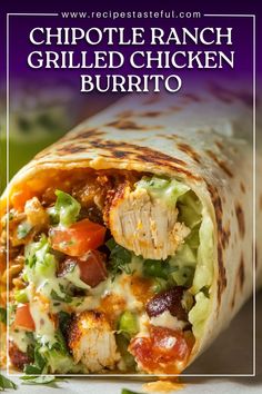 a burrito filled with chicken, lettuce and other toppings on top of it