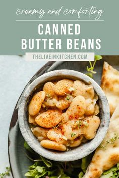 a bowl filled with food next to some pita bread