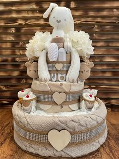 a diaper cake decorated with teddy bears and flowers