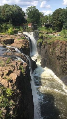 a large waterfall with water running down it's sides