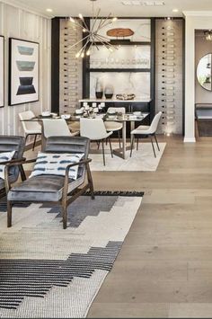 a living room filled with lots of furniture next to a dining room table and chairs