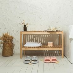 two pairs of slippers sitting on the floor next to a water dispenser