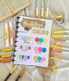 an open notebook with markers and crayons on it