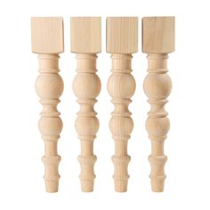 four wooden dowels are lined up on a white background