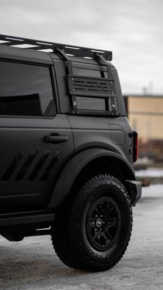 a black truck parked in front of a building