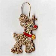 a dog ornament hanging from a hook on a white surface with a red ribbon around it's neck