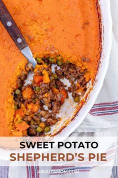 sweet potato shepherd's pie in a white dish with a wooden spoon on top