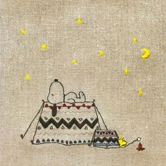 an embroidered picture of snoopy and his dog on the ground with stars in the sky