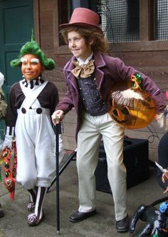 children dressed up as clowns and witches on the street