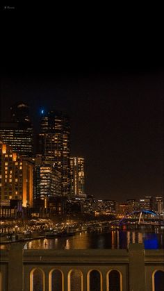 the city skyline is lit up at night