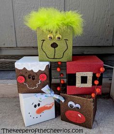 cardboard boxes with faces on them sitting in front of a door and some other decorations