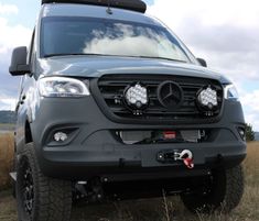 the front end of a grey mercedes benz truck