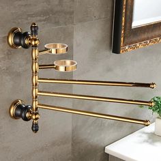 an antique brass towel rack in a bathroom