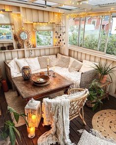 a living room filled with lots of furniture and decor on top of a wooden floor