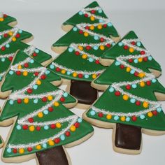 decorated christmas cookies arranged in the shape of trees