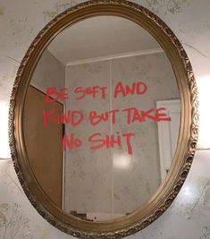 a mirror that has some writing on the side of it with red ink in it