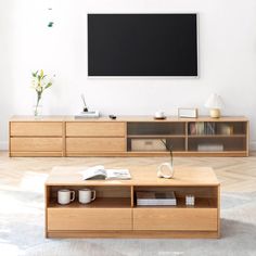 a living room with furniture and a flat screen tv mounted on the wall above it