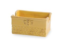 a yellow ceramic planter with a bee on the front and honeycombs on the back