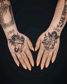 two hands that have tattoos on them