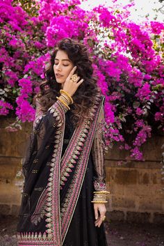 Black Chiffon Long Pishwas Pakistani Party Dresses is a glamorous dress tailored on a black canvas with heavily embellished borders with splashes of gold and Fuschia. Pishwas: An enchanting lehenga tailored on a black canvas with heavily embellished borders with splashes of gold and Fuschia. The Pishwas blouse features floral embroidery handworked over the sleeves and a gold-laced neckline. Lehenga can be customized with a frock. Dupatta: A gorgeous dupatta adorned with gota work and dainty moti Pishwas Pakistani, Pakistani Party Dresses, Glamorous Dress, Gota Work, Pakistani Bridal Dresses, Glamorous Dresses, Black Chiffon, Festive Wear, Lace Neckline