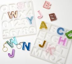 letters and numbers are made out of acrylic letter stencils on a white surface