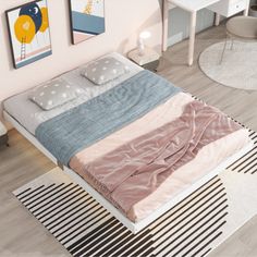 a bed sitting on top of a wooden floor next to a white desk and chair