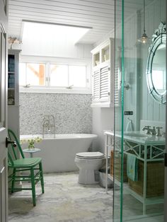 a bathroom with a tub, toilet and sink