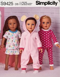 three dolls standing next to each other in pajamas