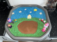 a cake made to look like a farm scene with pigs in the grass and houses