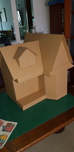 a cardboard house sitting on top of a table