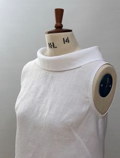 a mannequin wearing a white shirt with a clock on it