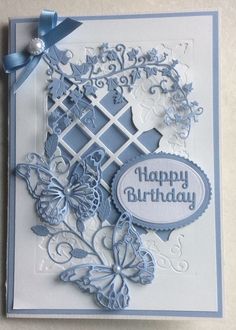 a close up of a birthday card on a white surface with blue ribbons and bows