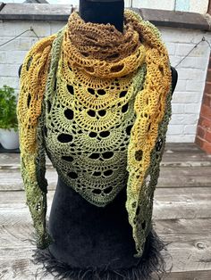 Wrap yourself in cozy comfort with this stunning Virus shawl, handmade using Hobbii Twister Zen Garden yarn. This lightweight yarn, made with 55% cotton and 45% acrylic, gives the shawl a soft, draping effect and features a beautiful ombré from brown to green, making it an absolutely stunning statement piece. At 210cm wide x 100cm tall (83in x 40in), this shawl is perfect for wrapping up warm in winter, yet lightweight enough for year-round use. You can wear it in multiple ways to best show off Brown Crochet Shawl For Fall, Fall Crochet Brown Shawl, Brown Crochet Bohemian Shawl, Bohemian Brown Crochet Shawl, Brown Bohemian Crochet Shawl, Green Bohemian Scarf For Fall, Green Crochet Shawl For Winter, Green Bohemian Crochet Shawl, Bohemian Green Crochet Shawl