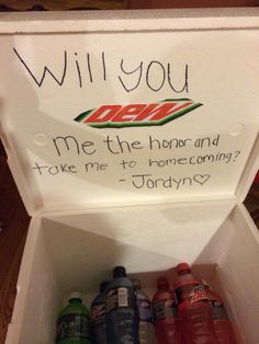 an open box filled with soda bottles and writing on the lid that says will you drink me the hour and take me to home coming?