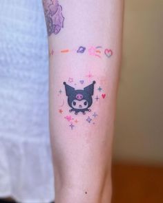 a person with a small tattoo on their arm that has an image of a cat