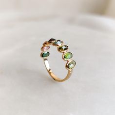 This stunning ring is set in 14k Solid Yellow Gold with Natural Multi Tourmaline and Diamond with utmost precision. It is an unique dainty gemstone ring for nearly every occasion and is completely hassle-free jewelry. ITEM DETAILS: * Gem: Multi Tourmaline * Gem Size: 3.5X4.5mm (36pcs) * Gem Shape: Oval * Gem Weight: 1.77 carats * Gem: Diamond * Gem Size: 1mm * Gem Weight: 0.08 carats * Gold Purity: 14K ~ also available in 18K * Gold Weight: 1.085 gram * Total Weight of the Ring: 1.455 gram The G October Birthstone Ring, October Birthstone Rings, Handmade Jewelry Box, Tourmaline Ring, October Birthstone, 14k Gold Ring, October Birth Stone, Christmas Present, White Rose Gold