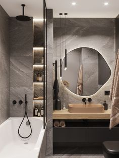 a bathroom with a large mirror, sink and bathtub in it's corner