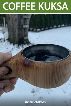 a person holding a wooden cup in the snow with text overlay that reads coffee kuska